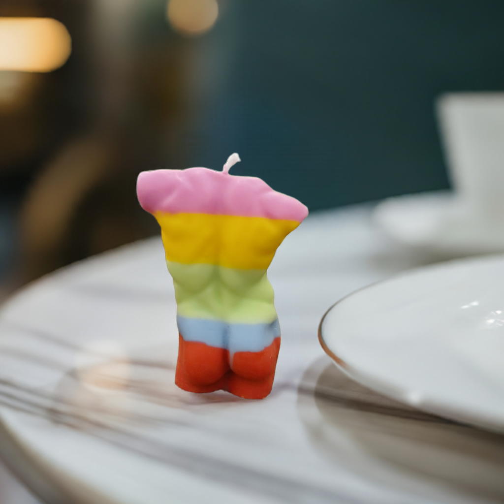 Vibrantly colored, color-poured wax candle by Scent Fushion Candles, shaped as a bold LGBTQ+ male figure—ideal for celebrating pride and adding a unique touch to any decor.